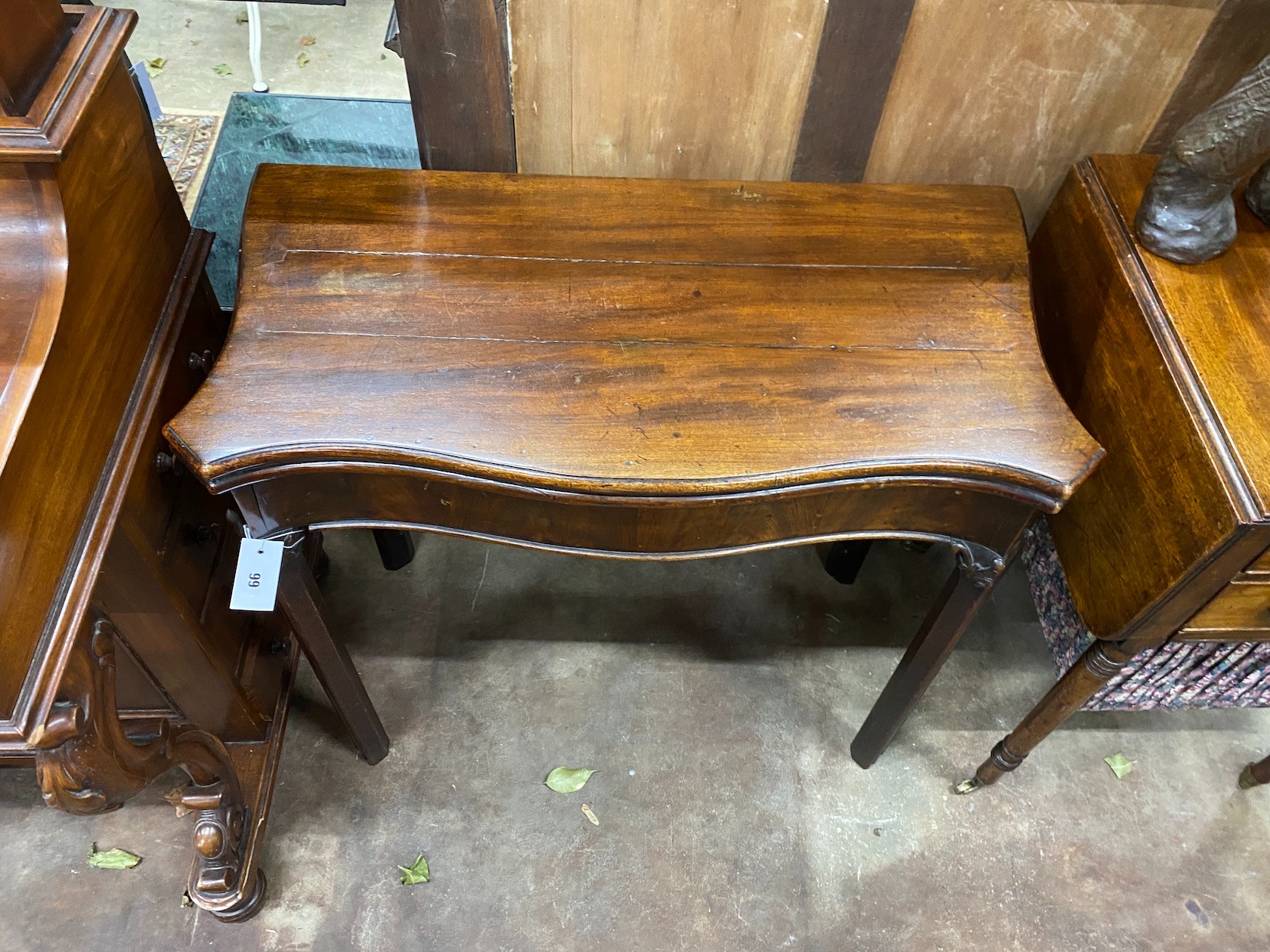 A George III serpentine mahogany foding card table, width 80cm, depth 40cm, height 73cm